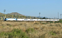 A locomotive hauled service from Alicante passes the site of Monforte Del Cid